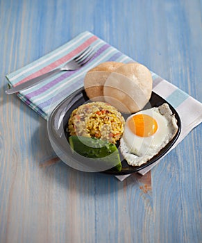 Asian fried rice homemade nasi goreng dish served with prawn crackers krupuk and sunny side up egg