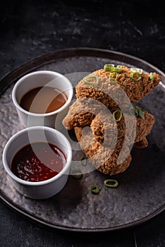 Asian fusion vegan meat-free jackfruit drumsticks with sweet hot sesame sauce and vegan BBQ