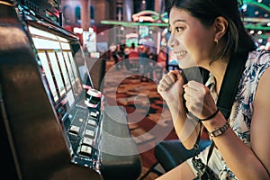 Asian gambling in casino playing slot machines