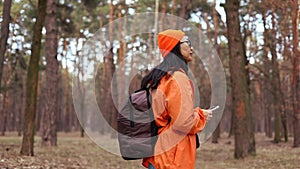 Asian Girl with Backpack Using Smartphone Gps. Woman Hiking In The Forest And Typing Message On Smartphone.