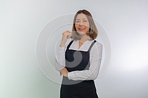 Asian girl barista wearing black apron, smiling standing bar counter
