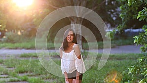 Asian girl beautiful female portrait walking away to the sun blur in the end