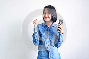 Asian girl with blue shirt left hand holding phone