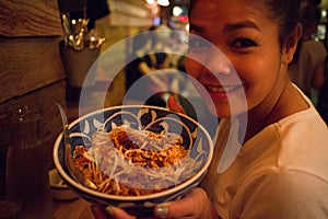 Asian Girl with a Bowl of Pad Thai at a Thai Restaurant in New York City