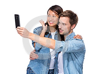 Asian girl and caucasian boy take selfie