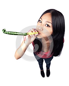 An Asian girl celebrating with a noise maker