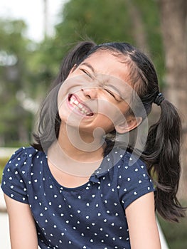 Asian girl child kid showing front teeth with big smile