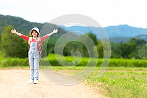 Asian girl children raise arms and standing see the outdoors, adventure and tourism for destination and leisure trips with mountai photo