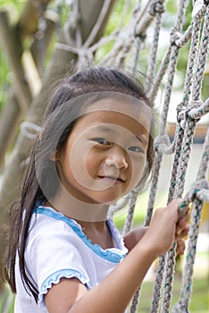 Asian Girl on climbing ladder in playground