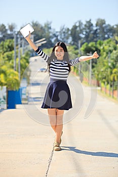 asian girl and computer tablet in hand standing with toothy smiling face use for people and internet connecting ,communication in