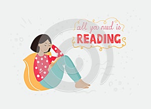 An asian girl with a dark hair in a bright clothing sitting with her back on her yellow pillow and reading a book