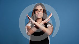 Asian girl disapproving with no crossing hands sign make negation gesture. Denying