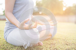 Asian girl doing yoga in garden with morning light
