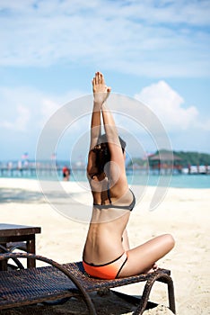 Asian girl doing Yoga on a recliner chair