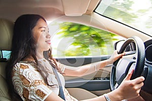 Asian girl driving a car