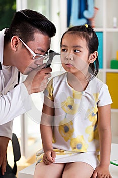 Asian girl during ear examination