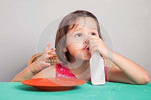 Asian girl eating a donut with milk