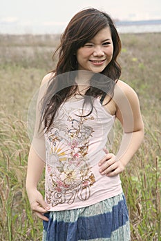 Asian girl among grass