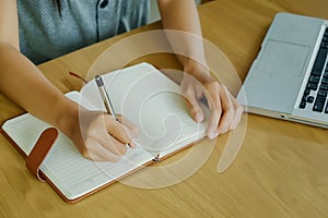 Asian girl hands with pen writing