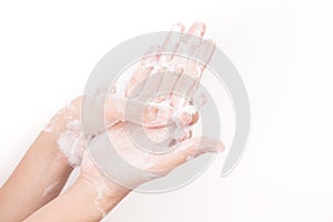 Asian girl hands are washing with soap bubbles on white background