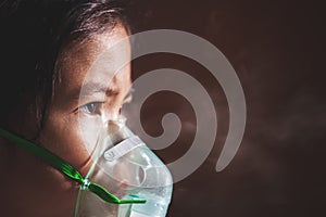 Asian girl has asthma or pneumonia disease and need nebulization by get inhaler mask on her face