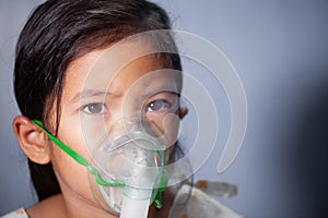 Asian girl has asthma or pneumonia disease and need nebulization by get inhaler mask on her face