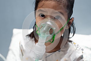 Asian girl has asthma or pneumonia disease and need nebulization by get inhaler mask on her face