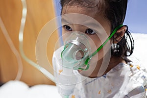 Asian girl has asthma or pneumonia disease and need nebulization by get inhaler mask on her face