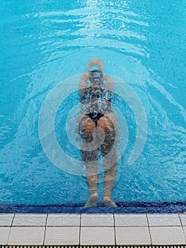 asian girl having afternoon swim in pool