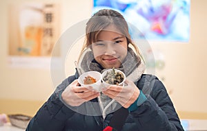 Asian girl having japanese Snack in a Izagaya bar and restuarant