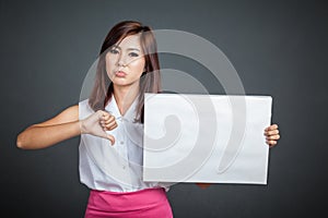 Asian girl hold blank sign and show thumbs down