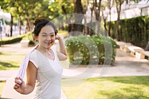 Asian girl hold towel at running park