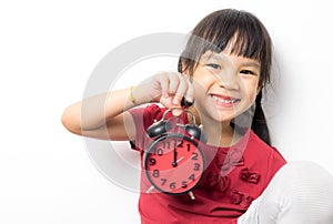 Asian girl is holding an alarm clock that count for lunch time.