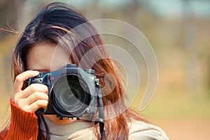 Asian girl holding a digital camer photo