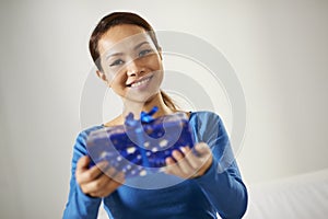 Asian girl holding gift box to the camera