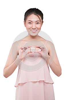 Asian girl is holding jar with moisturizing cream