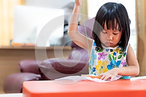 Asian girl home schooling sewing