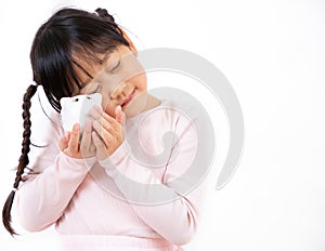 An Asian girl is hugging a piggy bank and dreaming of the future in a white background