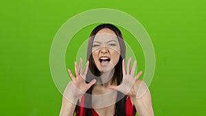 Asian girl is indignant with people, she is angry. Green screen