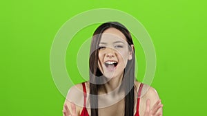 Asian girl is indignant with people, she is angry. Green screen. Slow motion