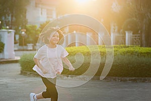 Asian girl jogging in sunny bright light