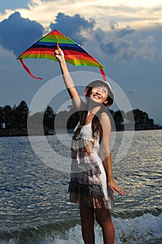 Asian Girl with kite under the sun photo