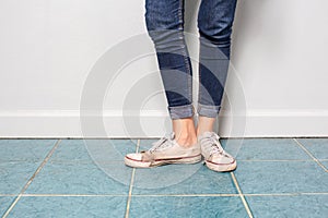 Asian girl leg with jean fashion with old shoes.