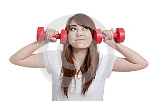 Asian girl lift dumbbells think of something