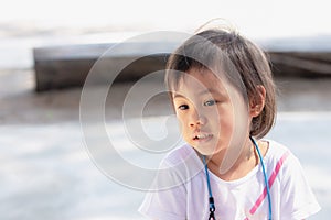 Asian girl, little toddler child looking at copy space. Absent minded children