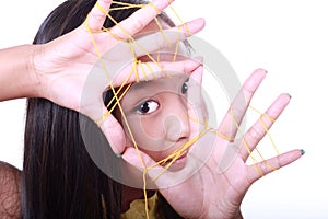 Asian girl looking through a thread