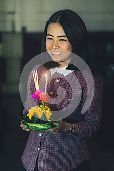 Asian girl in loy krathong Day near the river.