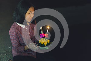 Asian girl in loy krathong Day near the river.