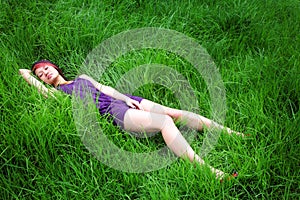 Asian girl lying on grass