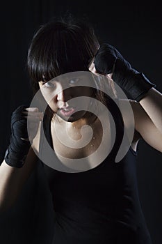 Asian girl Muay Thai fighter in defensive position